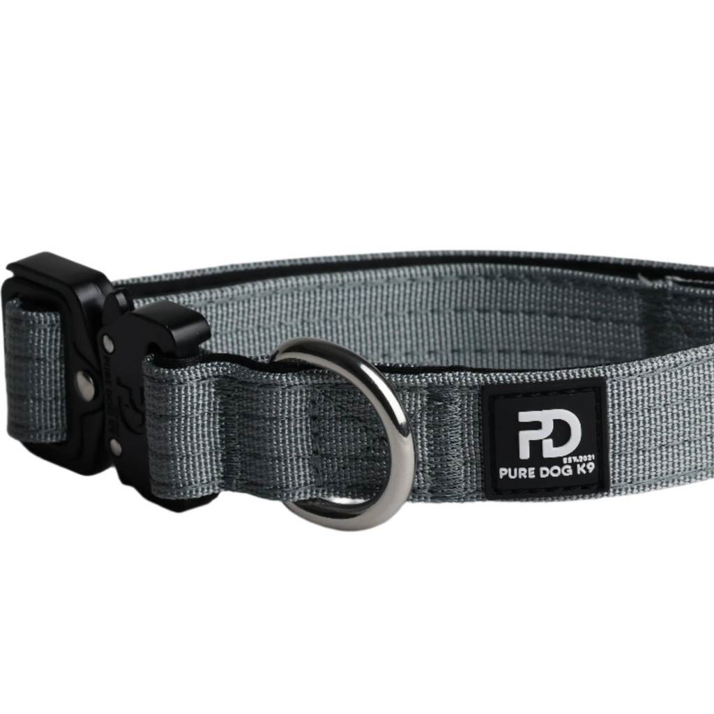 Grey tactical dog collar with black buckle, metal D-ring, and logo patch
