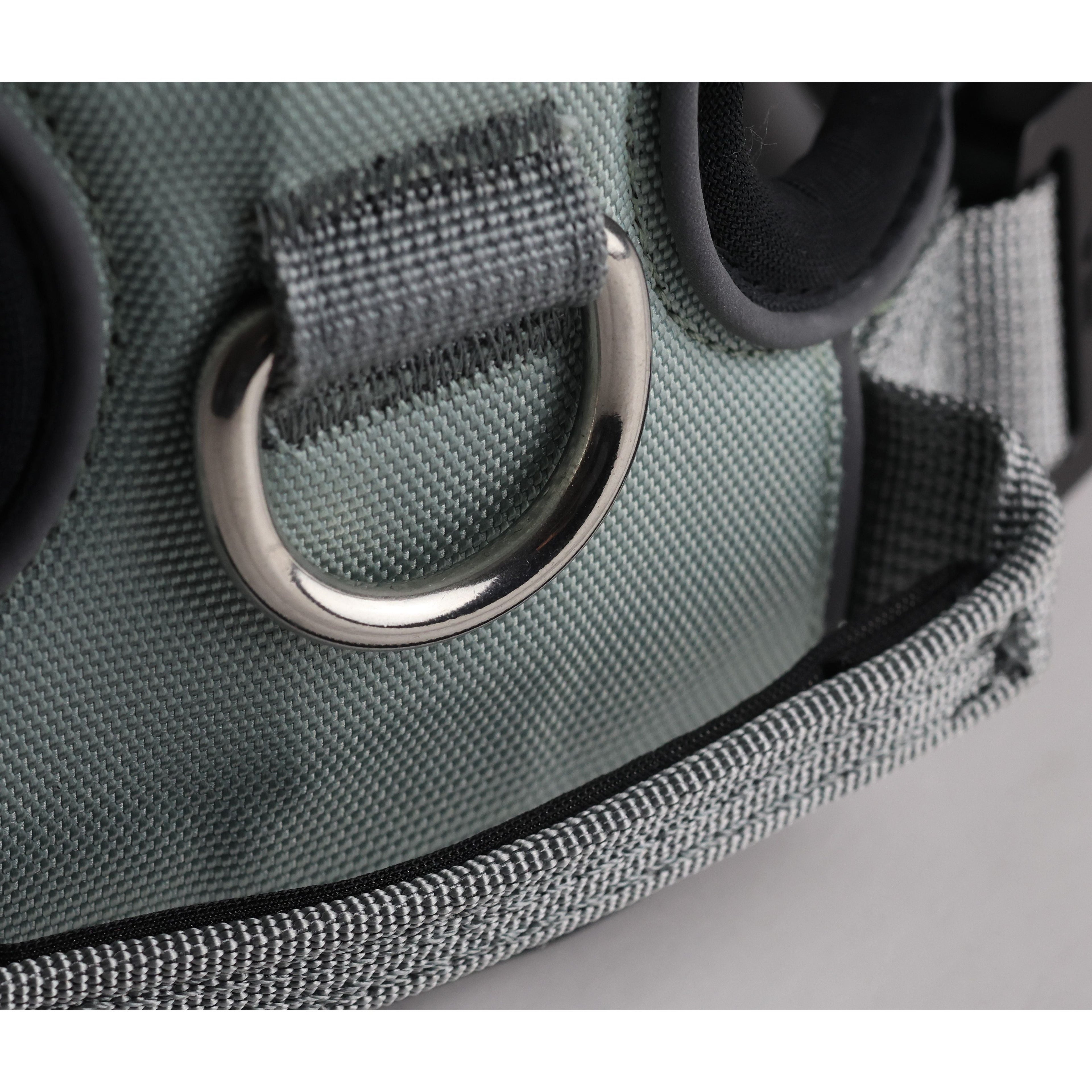 Grey padded dog harness close-up of front metal D-ring on fabric panel
