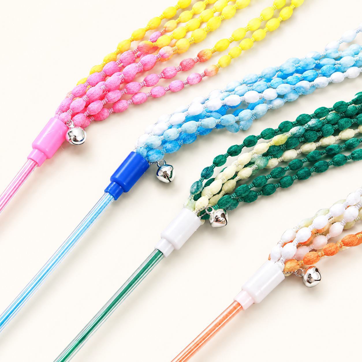 Cat stick toy close-up: multi-color beaded ribbon ropes on colored wand stems