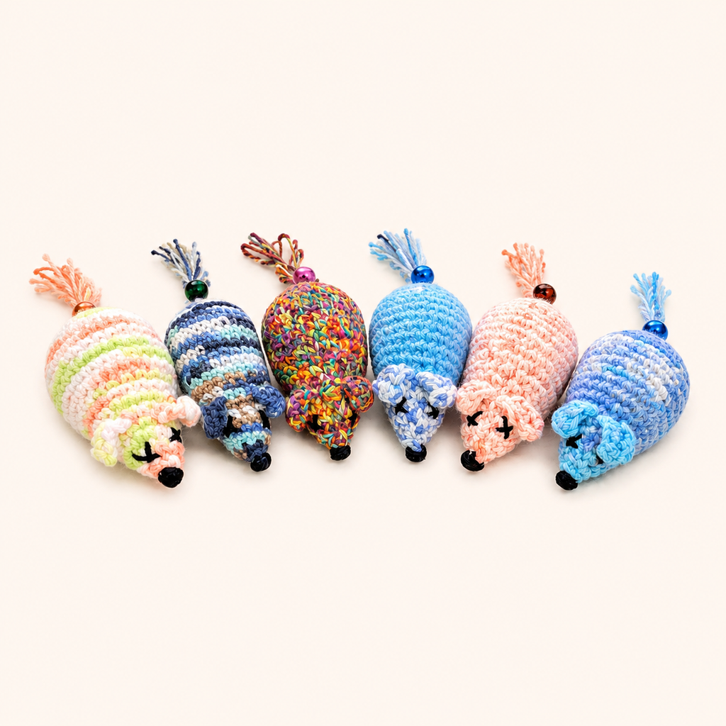 Catnip crochet mouse toys, assorted colors in a row; fuzzy yarn tails and bead eyes