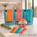 Dog supplement bundle with three striped pouches, sample sticks, and pink paw-shaped mold