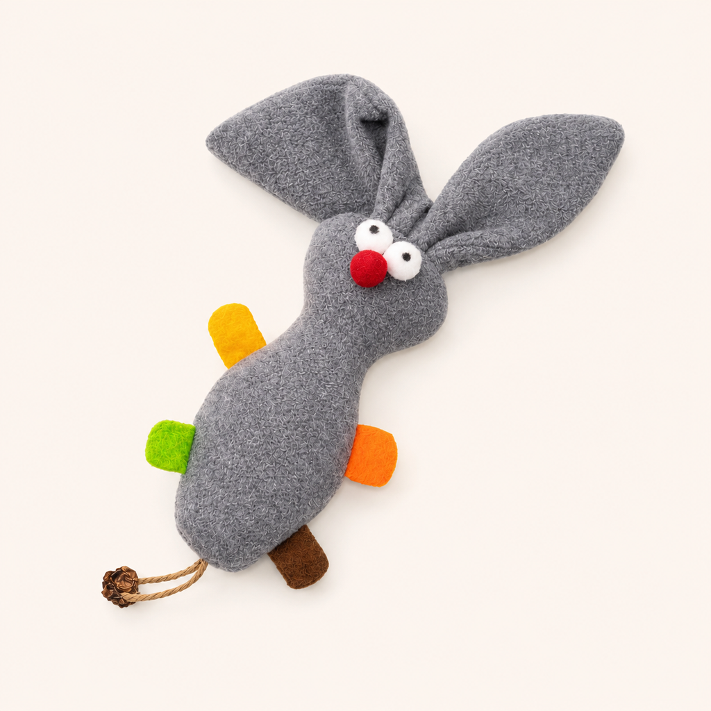 Gray plush rabbit-cat toy with long ears, red nose, white eyes, and brown paw pads.