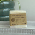 Tan natural dog shampoo bar with You rolled in what printed label
