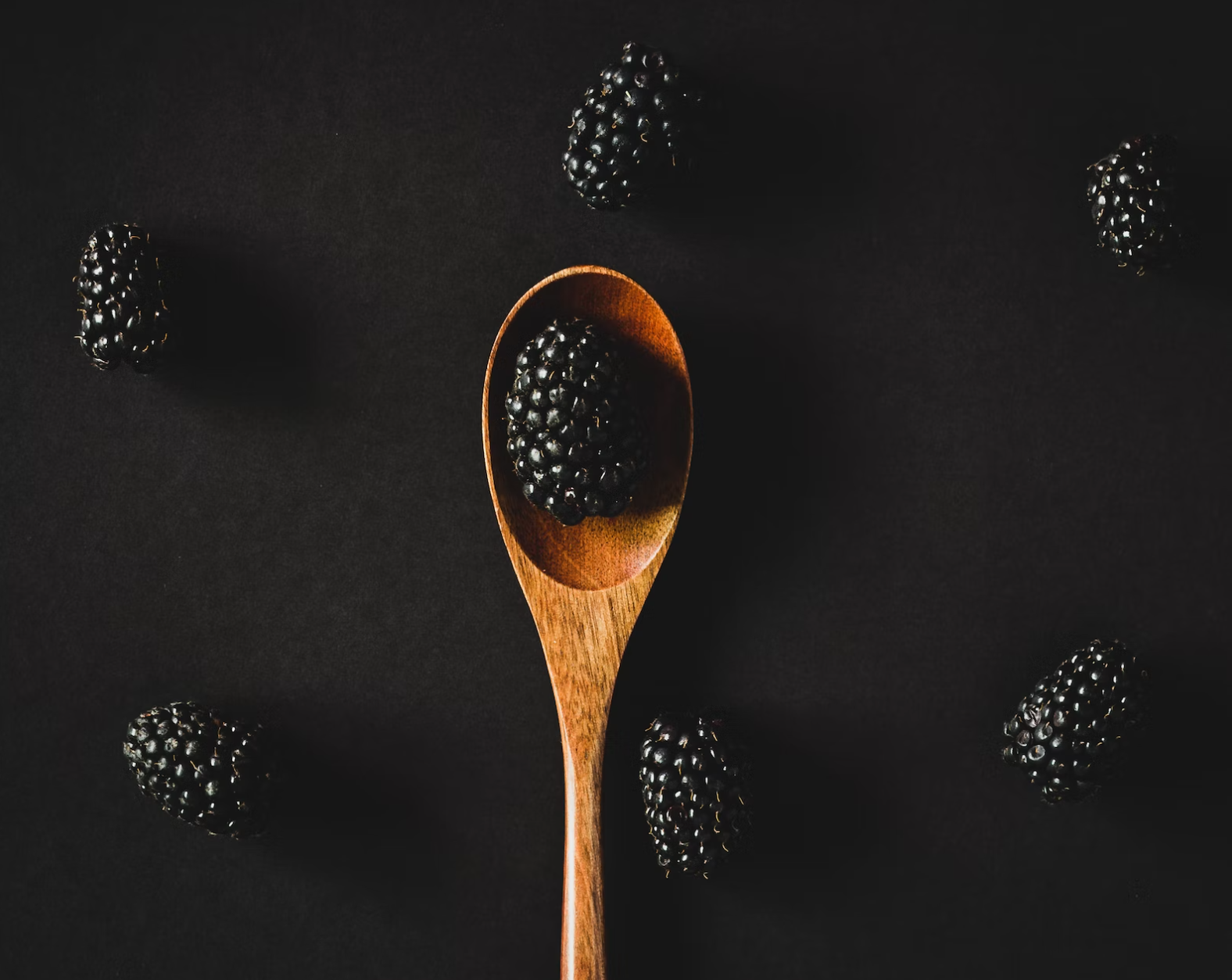 Wooden spoon filled with small rabbit kibble pieces