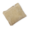 Beige plush dog blanket with sewn label on corner