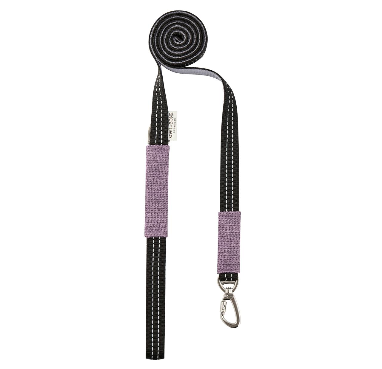 Dog lead with purple padded handle, black dotted webbing, and metal clasp.