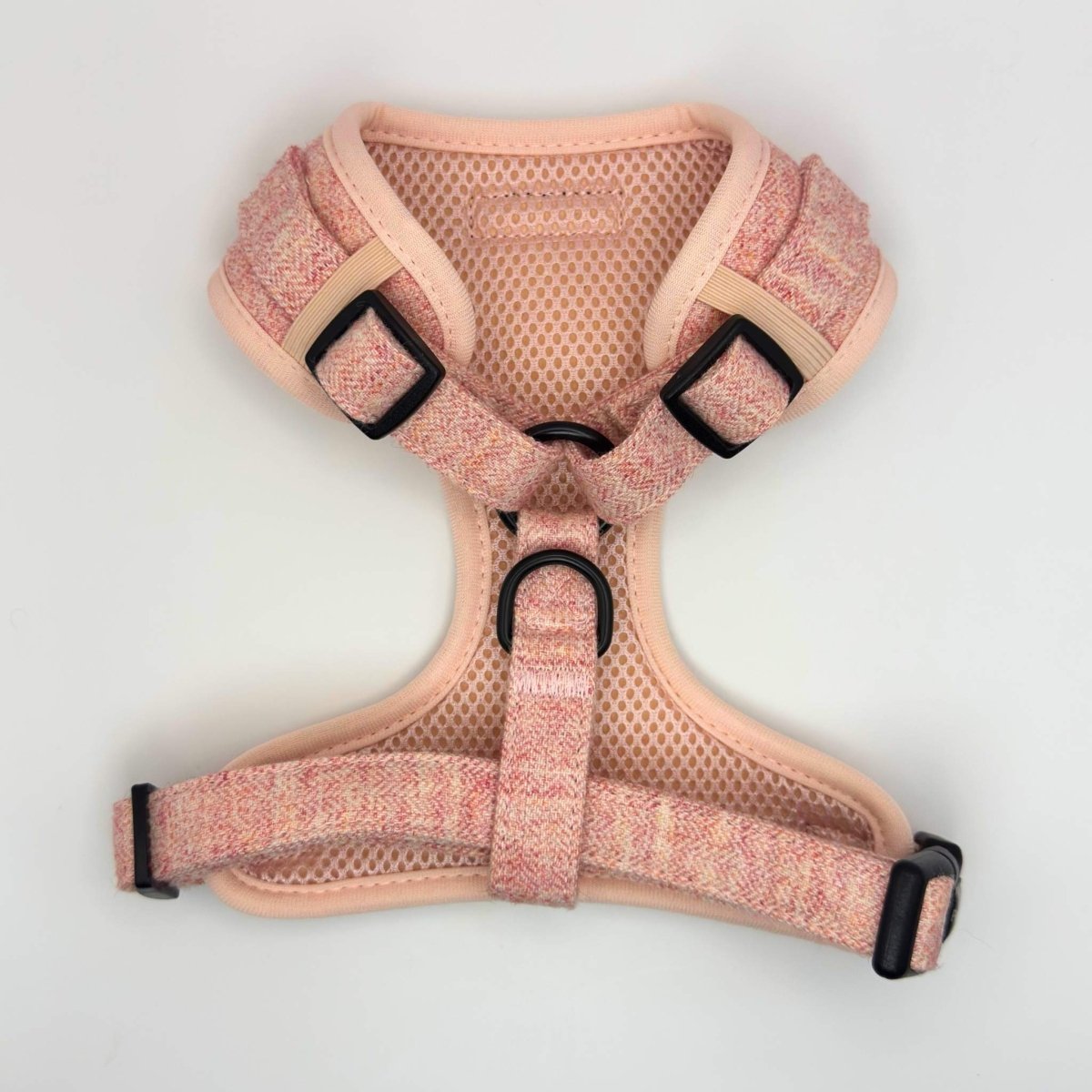 Pink tweed dog harness with mesh lining, adjustable straps, and PupClub logo