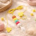 Hanging cat toy with yellow rope, orange caterpillar plush, feather tail, cloud charm