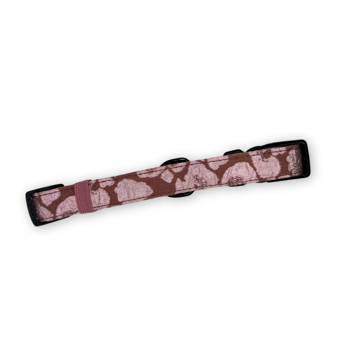 Mocha petal dog collar with black trim and adjustable ring, flat lay view