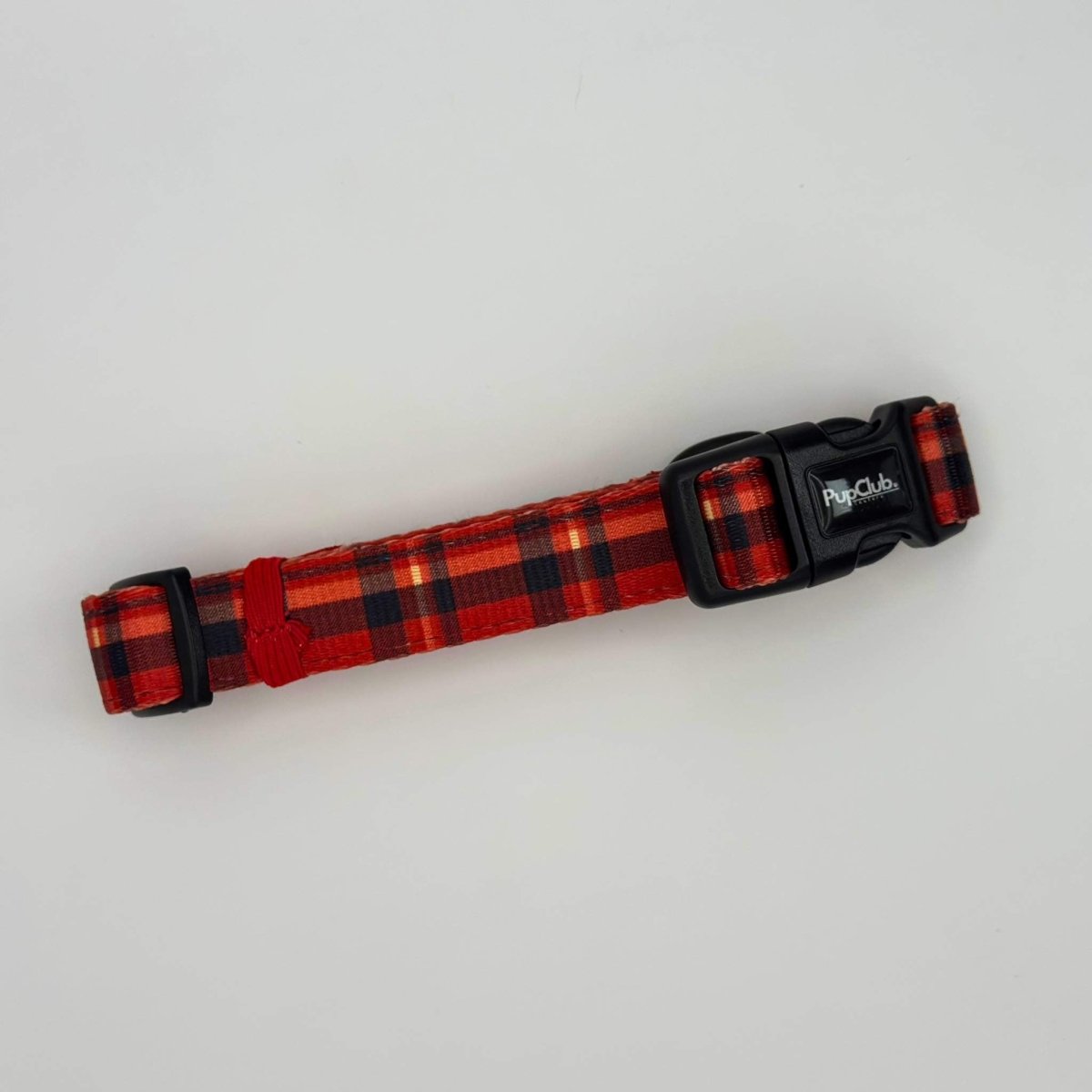 Red tartan dog collar with black adjustment slider and PupClub logo