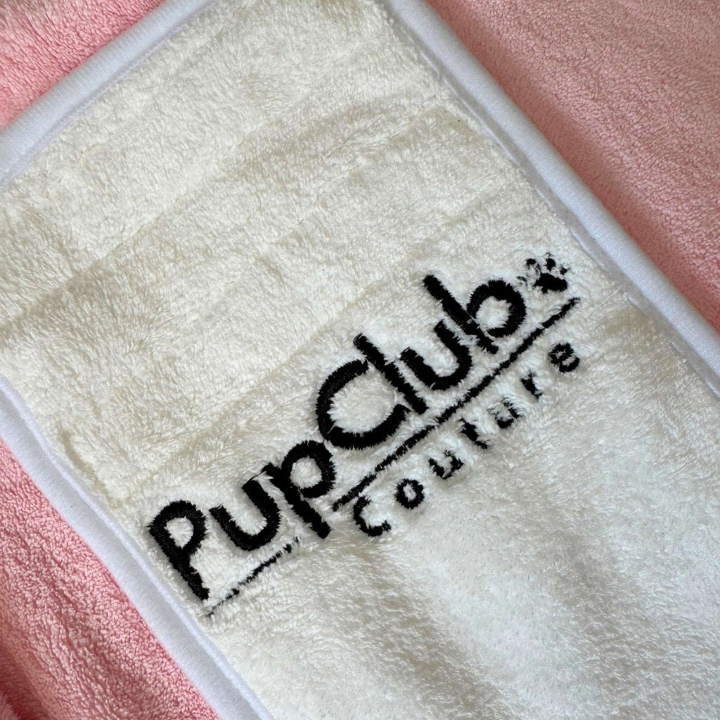 PupClub embroidered logo on light patch of a pink hooded drying robe