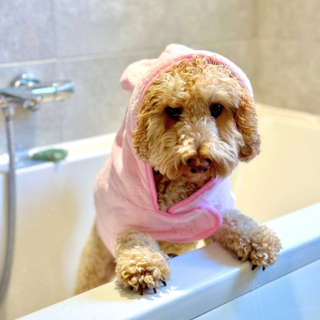 Pink hooded drying robe with soft terry texture and front pocket detail