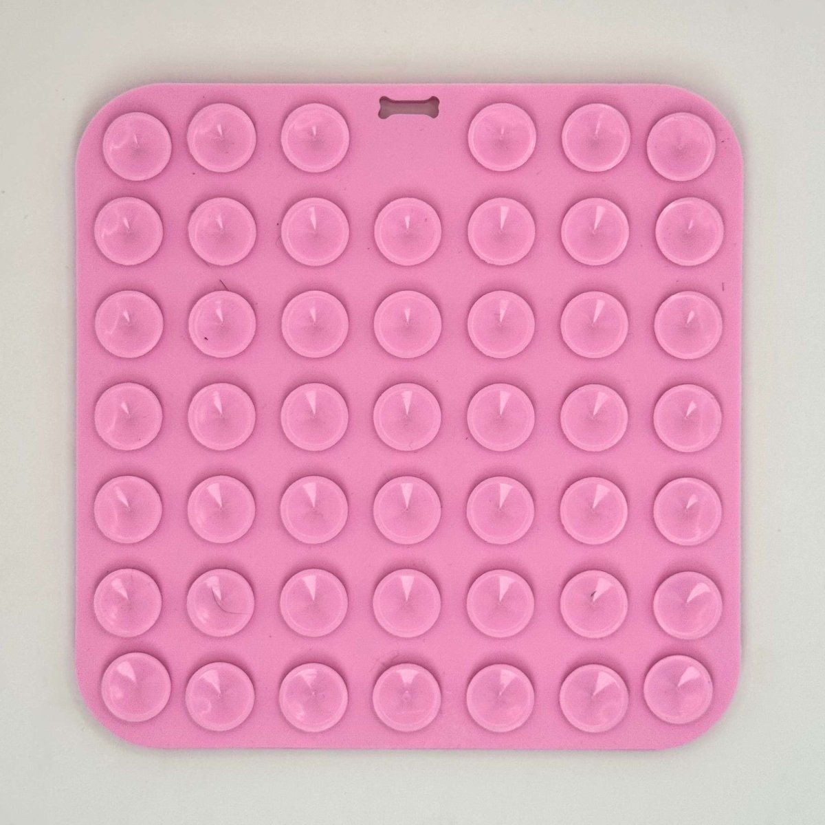 PupClub Couture pink silicone dog lick mat with raised round nibs across surface