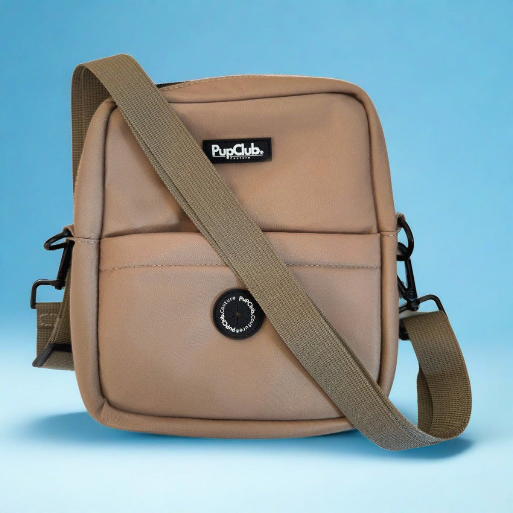 Tan mini crossbody dog bag with PupCub logo, front panel, and web shoulder strap