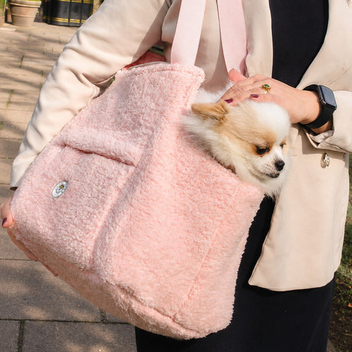 Blush rose faux-fur dog carrier with flap, held open for a small dog