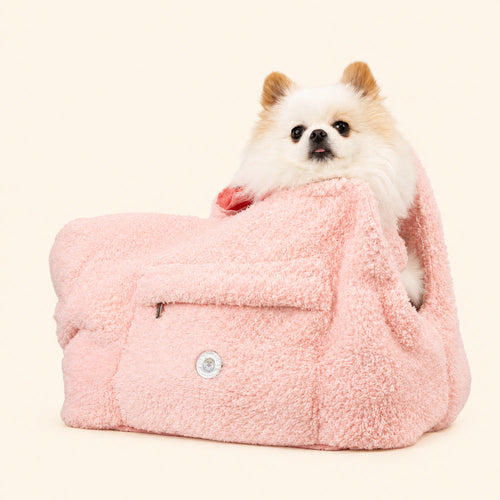Blush rose faux-fur dog carrier with small dog sitting inside