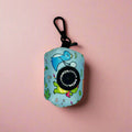 Round dinosaur-print poop bag holder pouch with black strap and zipper, teal and light blue