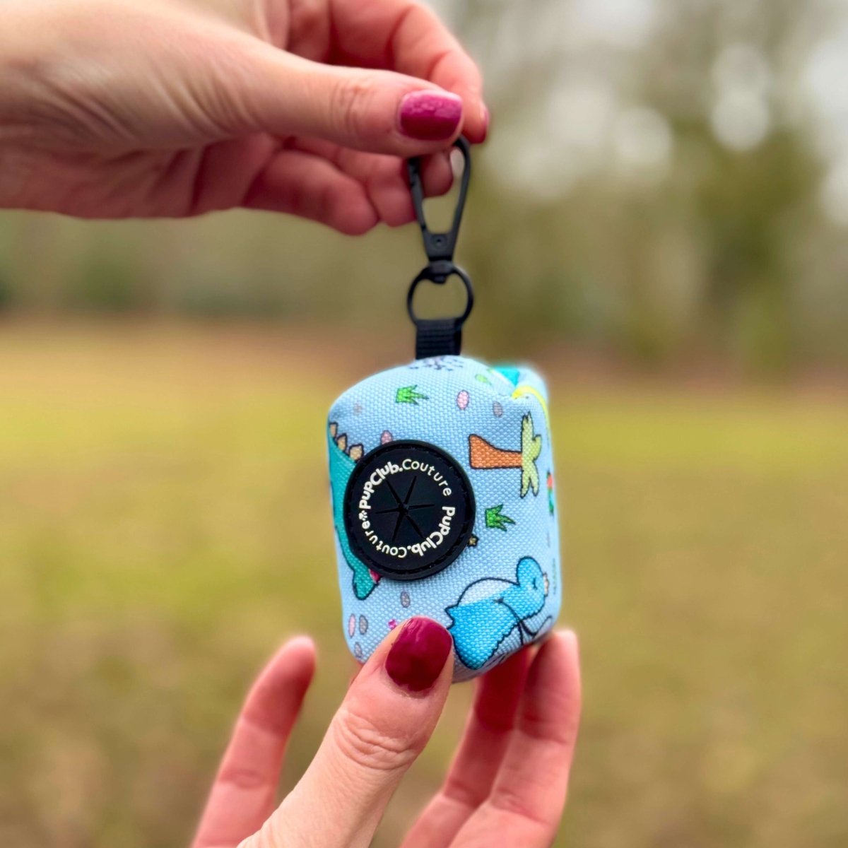 Poop bag holder pouch with dinosaur print, black clip strap, teal and light blue
