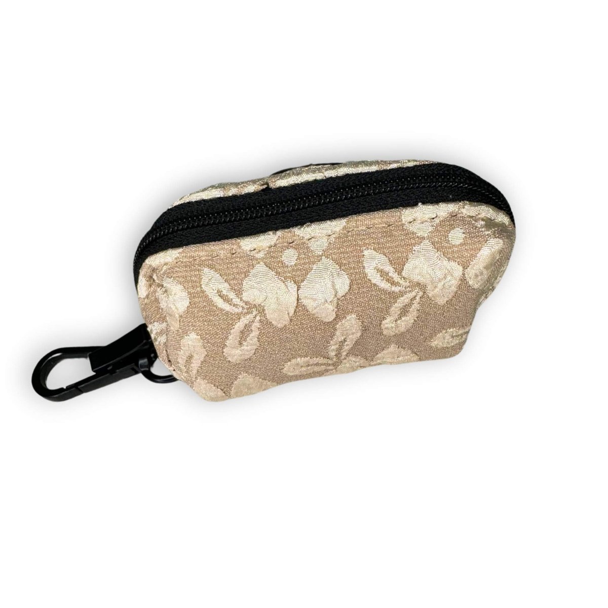 Pet waste bag holder pouch with leaf print, black zipper trim, and clip strap