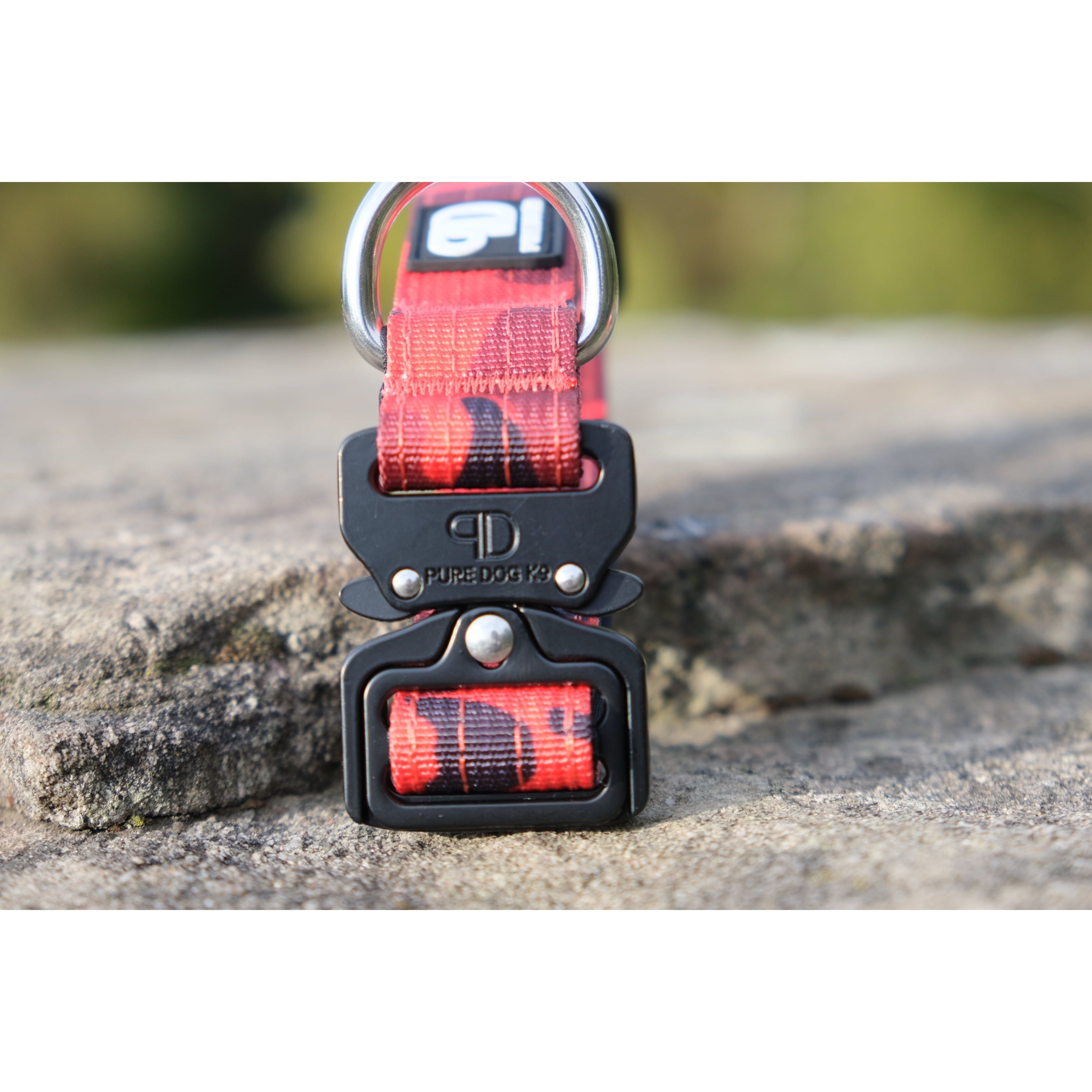 Tactical dog collar clasp close-up with black fastener on red camo strap
