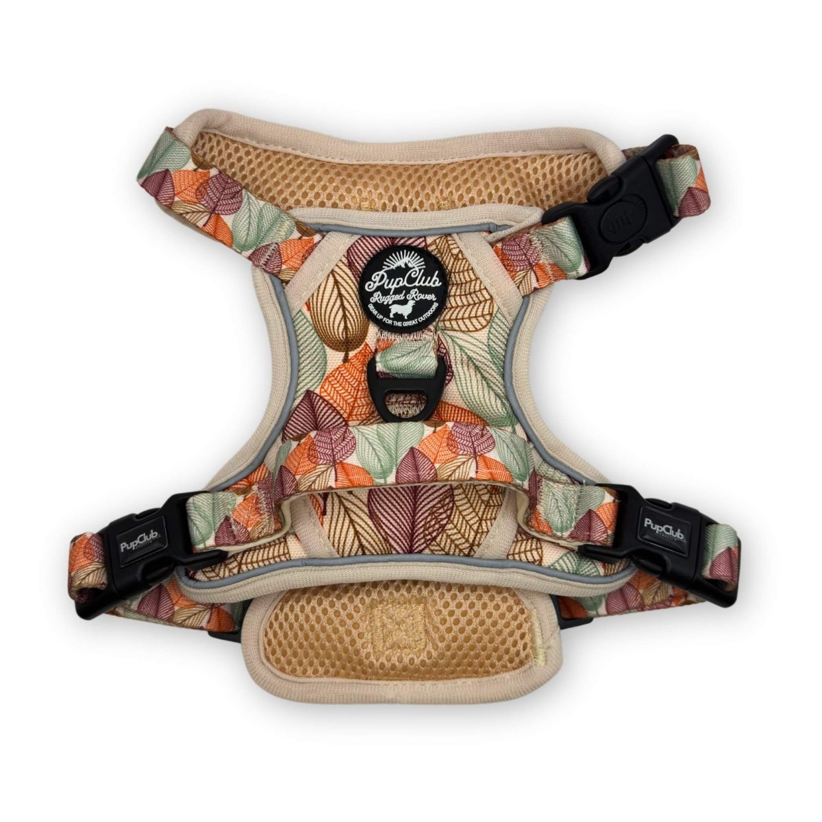Dog harness with leaf-pattern fabric, tan trim, and black adjustable buckles