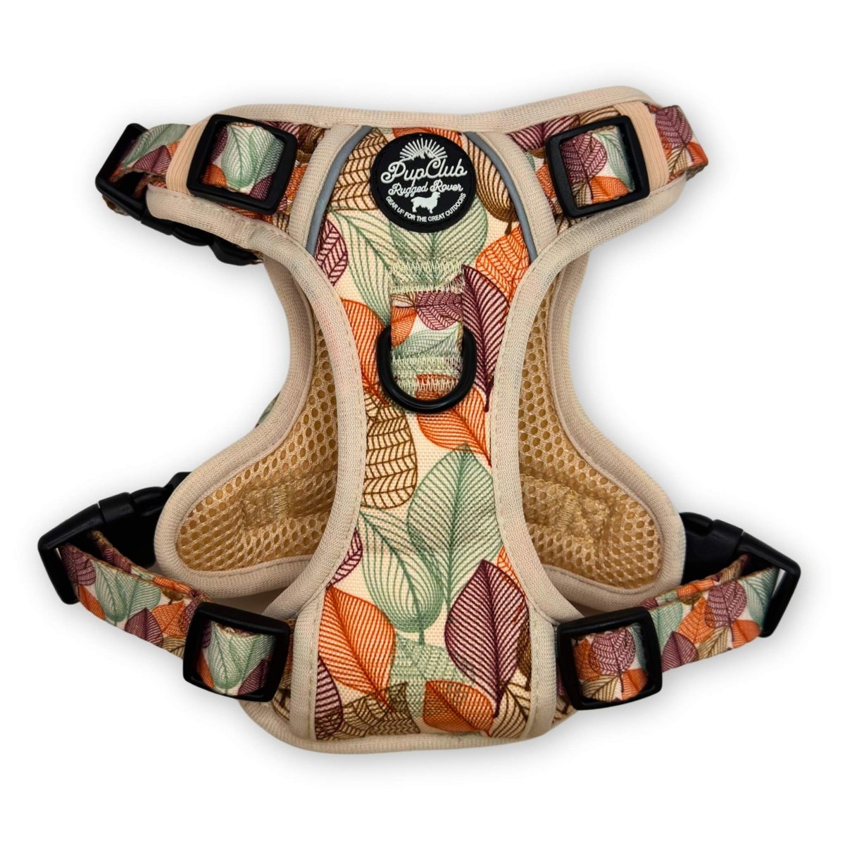 Dog harness with autumn leaf print, tan mesh padding, and black buckle straps