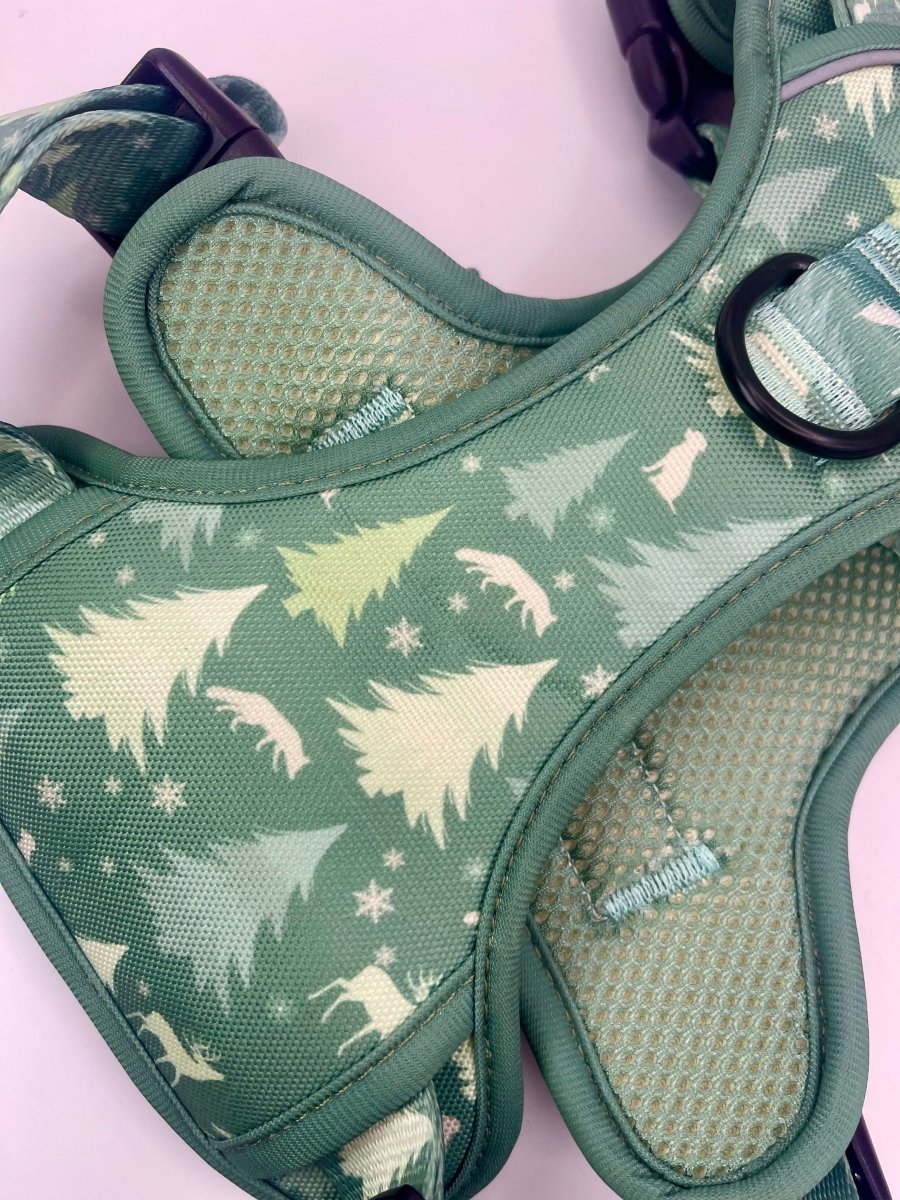 Close-up of green evergreen trails dog harness with tree print and padded panels