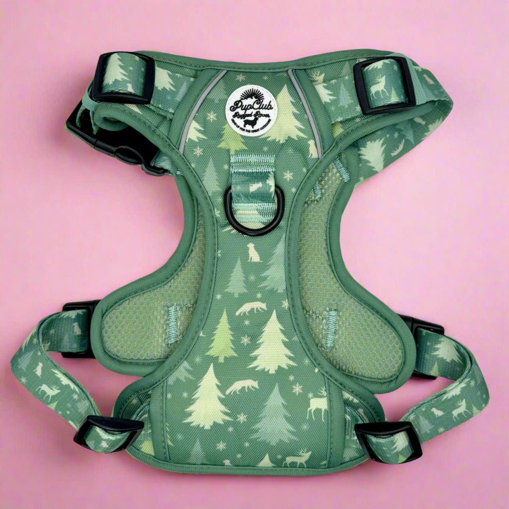Green evergreen trails dog harness with tree pattern, front view with buckles