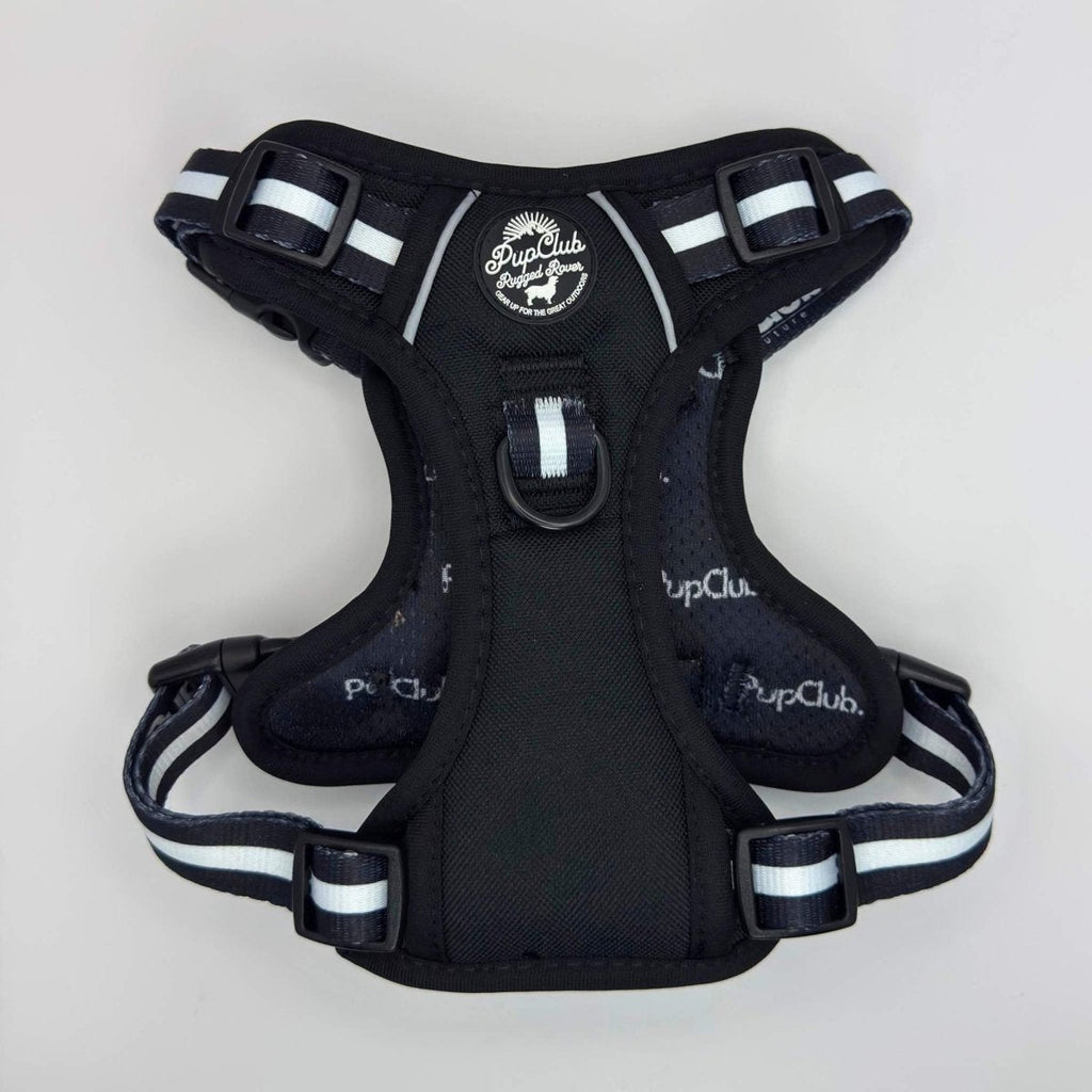 Midnight black dog harness with front handle, chest strap, and white striped webbing