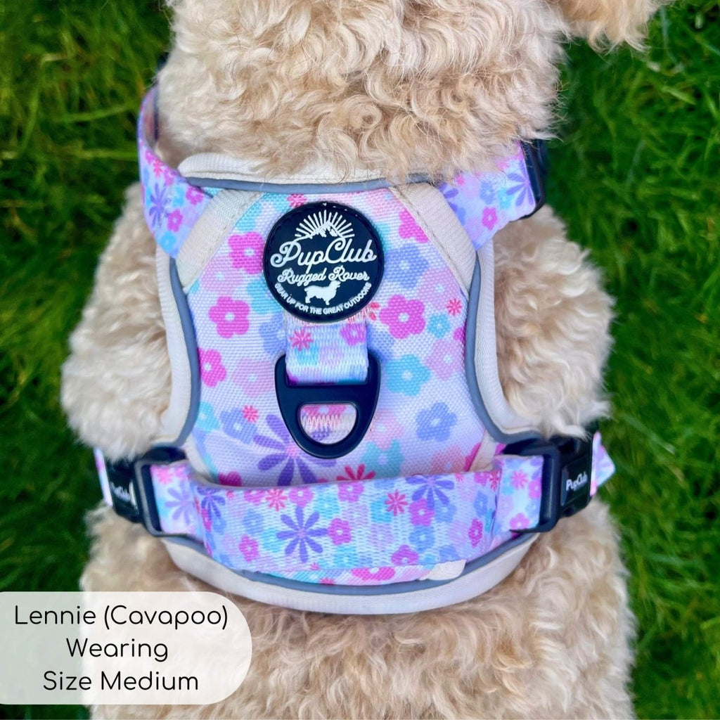 Close-up of pastel floral padded dog harness with mesh panels and black front clasp