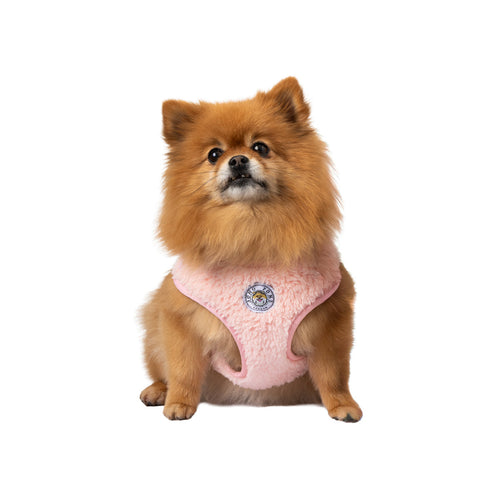 Pink plush dog harness with logo patch, front opening and black buckle