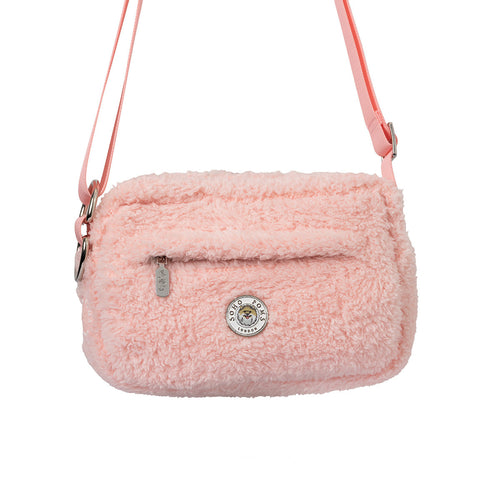 Blush pink faux-fur walking bag with crossbody strap, front zipper and round logo badge